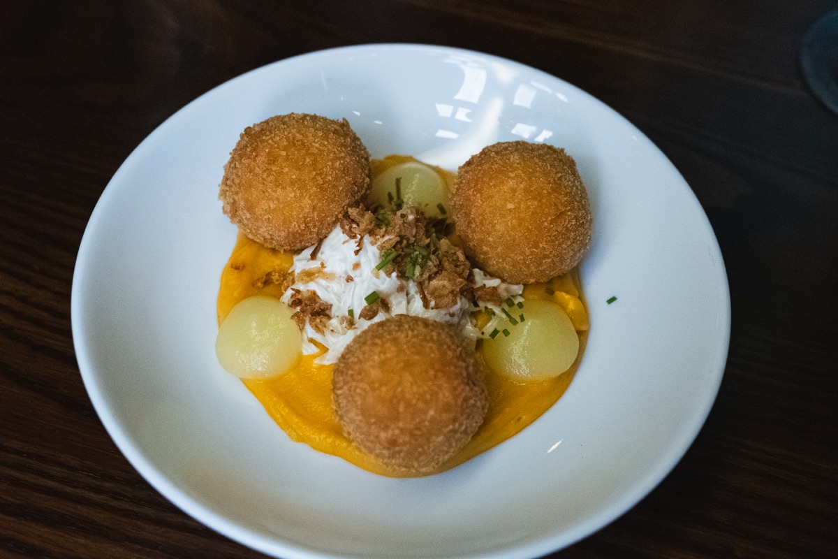 Arancini on squash puree with crispy shallots