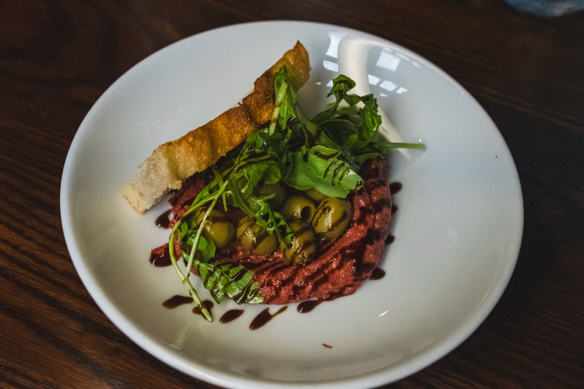 Beetroot houmous with green olives, rocket and toasted focaccia