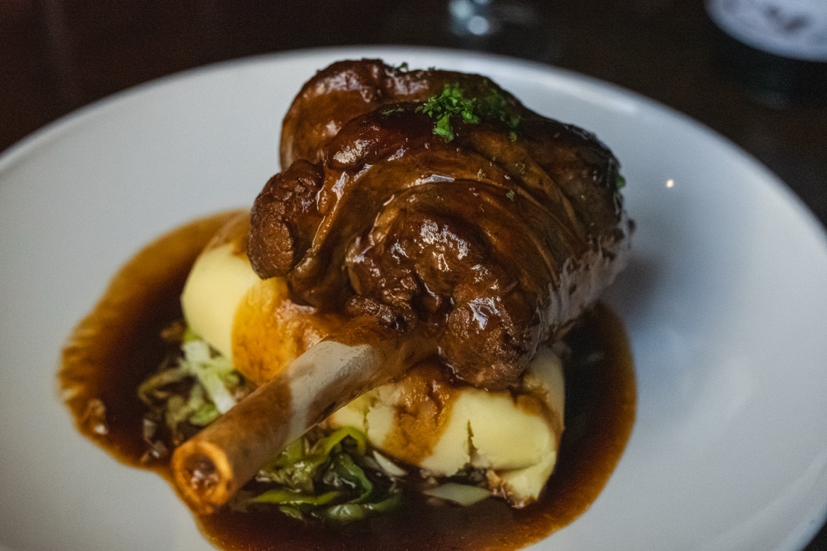 Braised lamb shank with mash and buttered cabbage