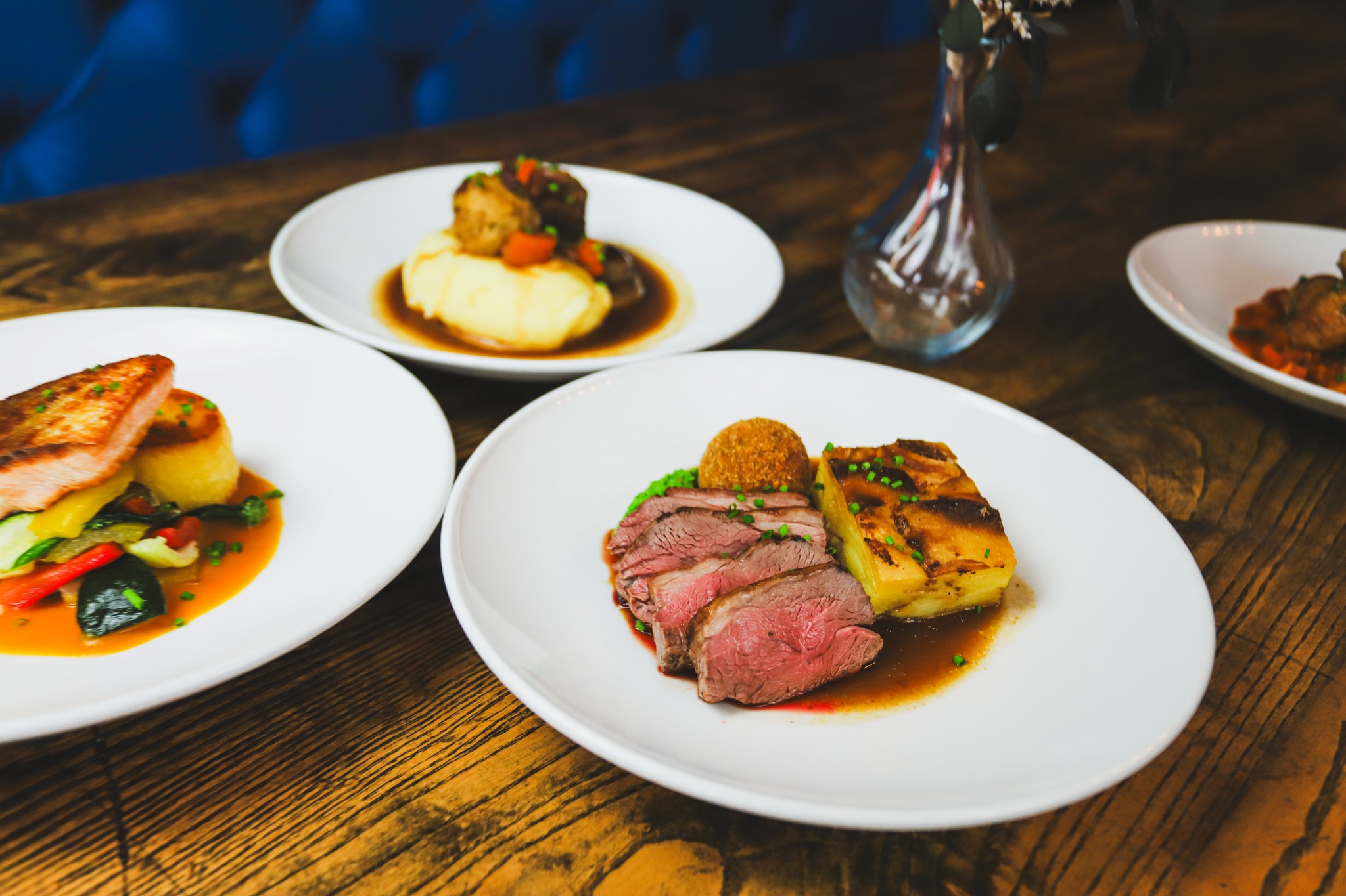 A table of dishes on the blue banquette at Lawson's